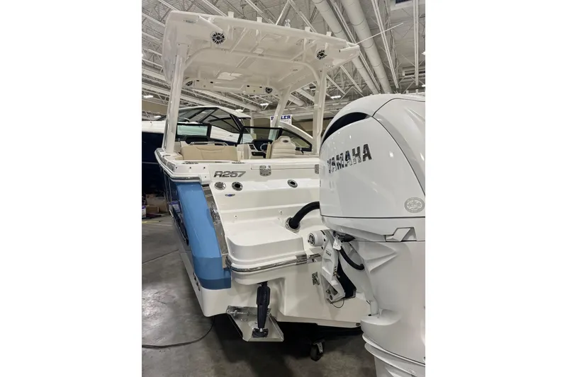 Slide: The Image of 2026 Robalo R257 Dual Console boat with Yamaha engine in showroom. - 3