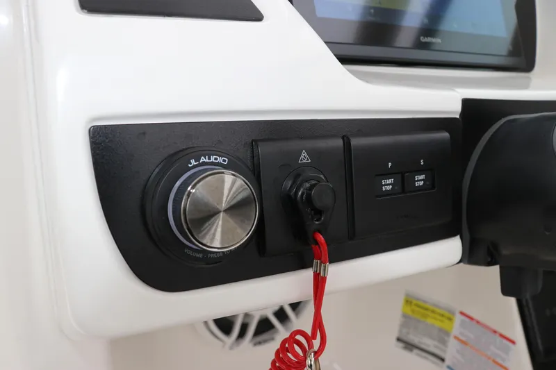 Slide: The Image of 2026 Robalo R257 Dual Console boat seat, white and gray upholstery, sleek design. - 31