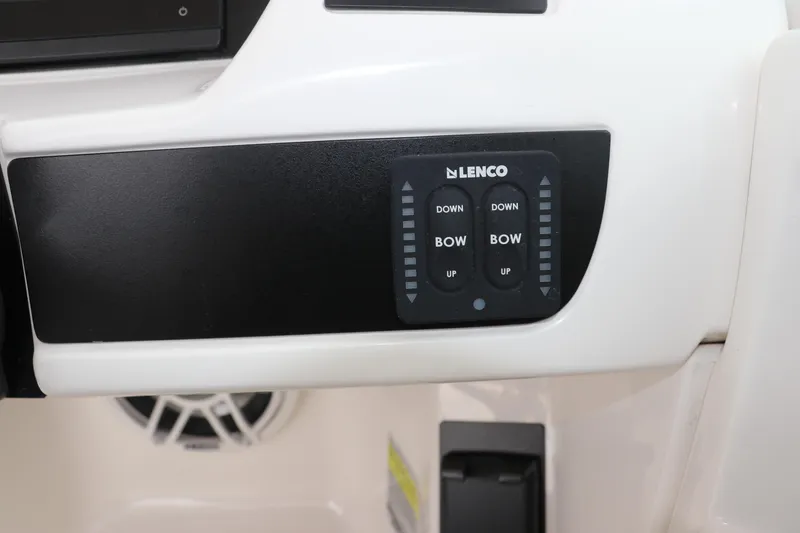 Slide: The Image of 2026 Robalo R257 Dual Console boat dashboard with steering wheel and navigation display. - 33