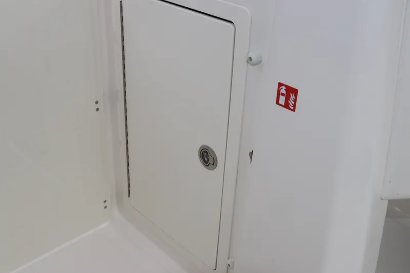 Slide: The Image of Charging station on 2026 Robalo R257 Dual Console boat with safety labels. - 39