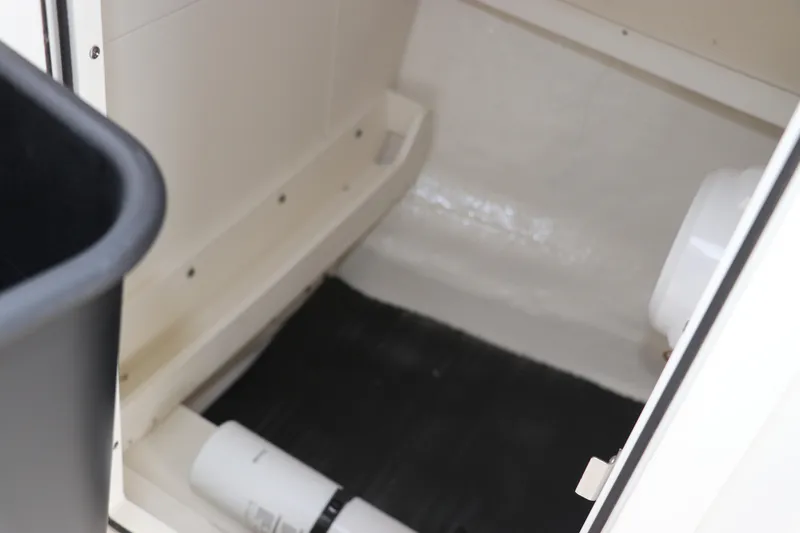 Slide: The Image of 2026 Robalo R257 Dual Console deck hatch with seating detail. - 41
