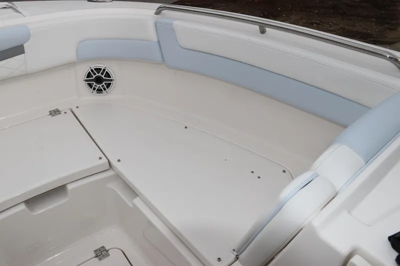 Slide: The Image of 2026 Robalo R257 Dual Console boat interior with seating and speakers. - 47