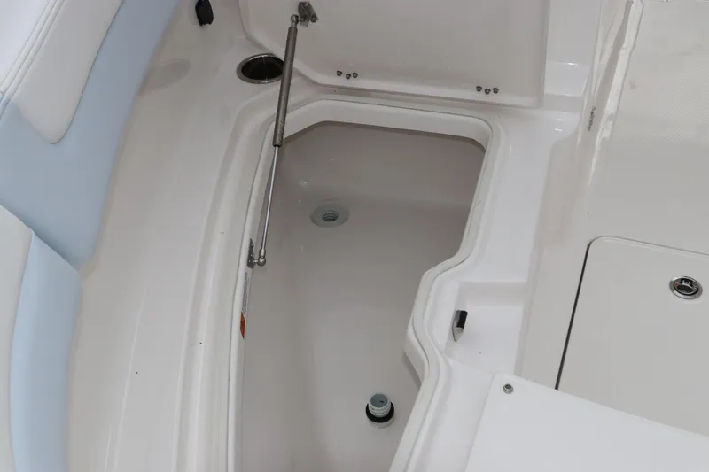 Slide: The Image of 2026 Robalo R257 Dual Console boat storage compartment with open hatch. - 54
