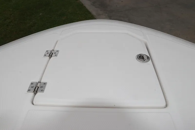 Slide: The Image of 2026 Robalo R257 Dual Console boat hatch with stainless steel hinges and latch. - 59