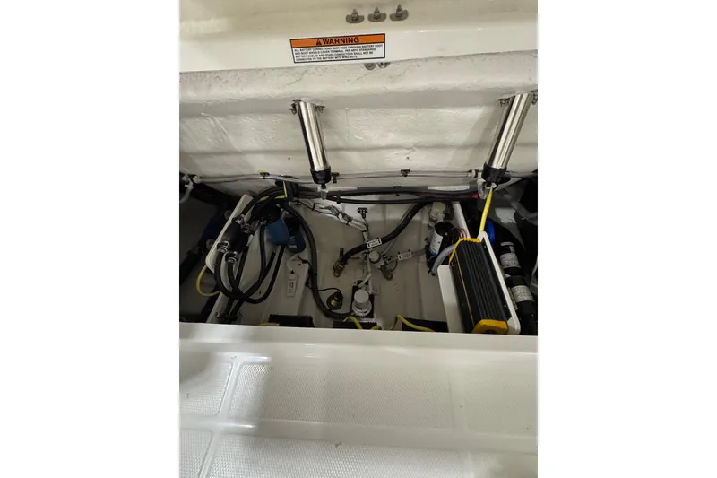 Slide: The Image of 2026 Robalo R257 Dual Console engine compartment with hydraulic systems and wiring. - 7