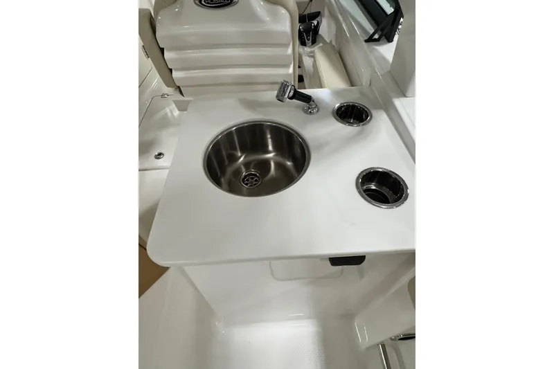 Slide: The Image of 2026 Robalo R257 Dual Console boat sink and countertop detail. - 8
