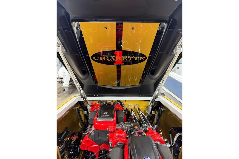 Slide: The Image of 2018 Cigarette 42X engine compartment with vibrant red components and branded cover. - 15