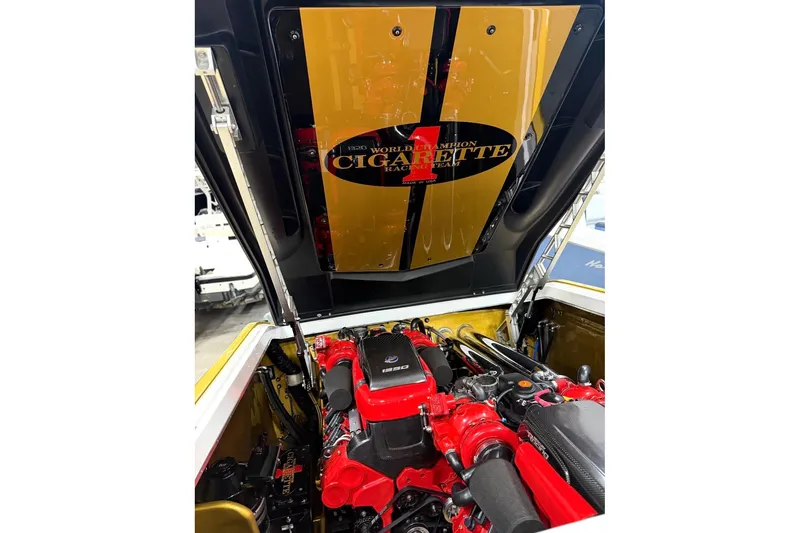 Slide: The Image of Engine compartment of a 2018 Cigarette 42X boat, showcasing powerful red engine components. - 16
