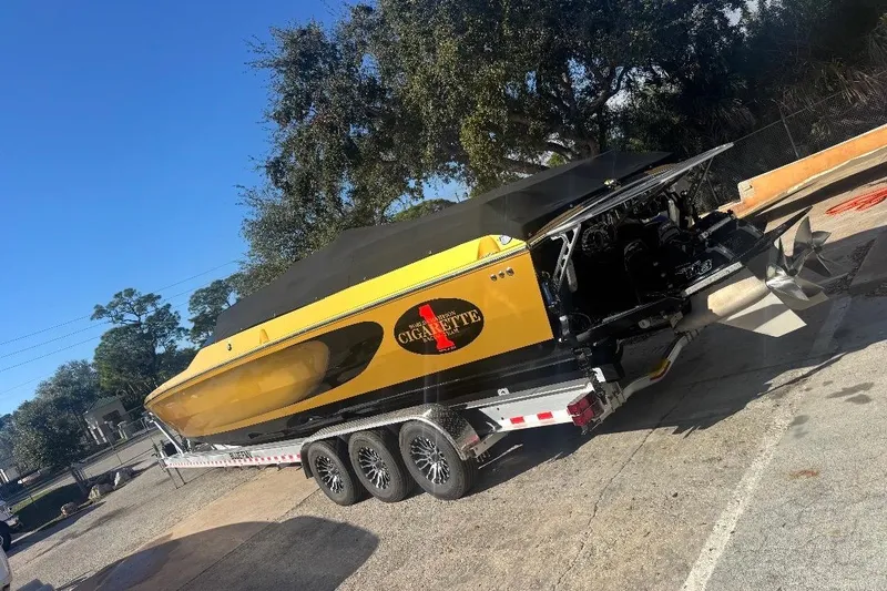 Slide: The Image of 2018 Cigarette 42X powerboat on trailer, yellow and black design, parked outdoors. - 3