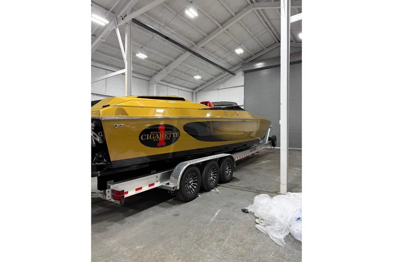 Slide: The Image of 2018 Cigarette 42X powerboat in a warehouse, yellow and black design on a trailer. - 5
