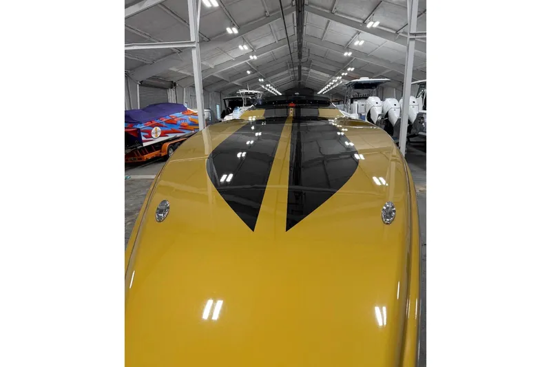 Slide: The Image of Yellow 2018 Cigarette 42X boat with black stripes in a storage facility. - 8