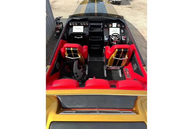 Slide: The Image of 2018 Cigarette 42X boat cockpit with red seats and advanced navigation system. - 9