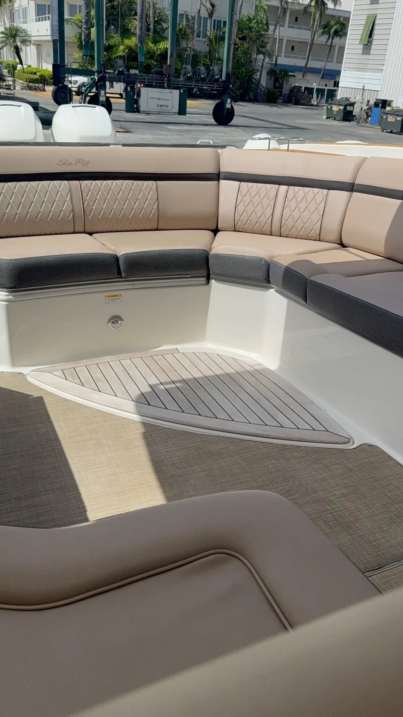 Slide: The Image of The image shows the interior of a 2018 Sea Ray SLX 350 Outboard with elegant seating. - 18