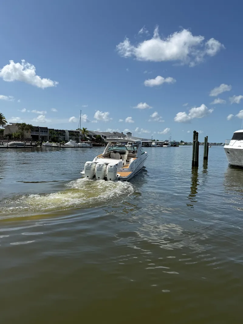 Slide: The Image of A 2018 Sea Ray SLX 350 Outboard cruising on calm waters under a blue sky. - 29