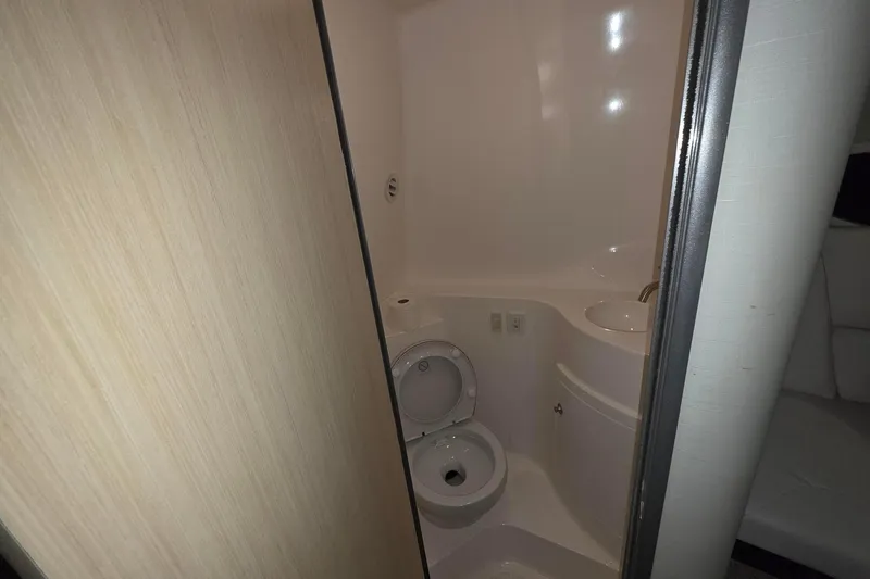 Slide: The Image of 2023 Regal 26 XO boat bathroom with toilet and sink, compact and modern design. - 12