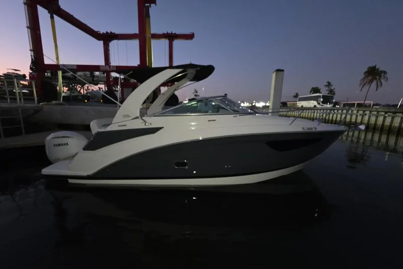 Slide: The Image of 2023 Regal 26 XO boat docked at sunset, featuring sleek design and Yamaha engine. - 2