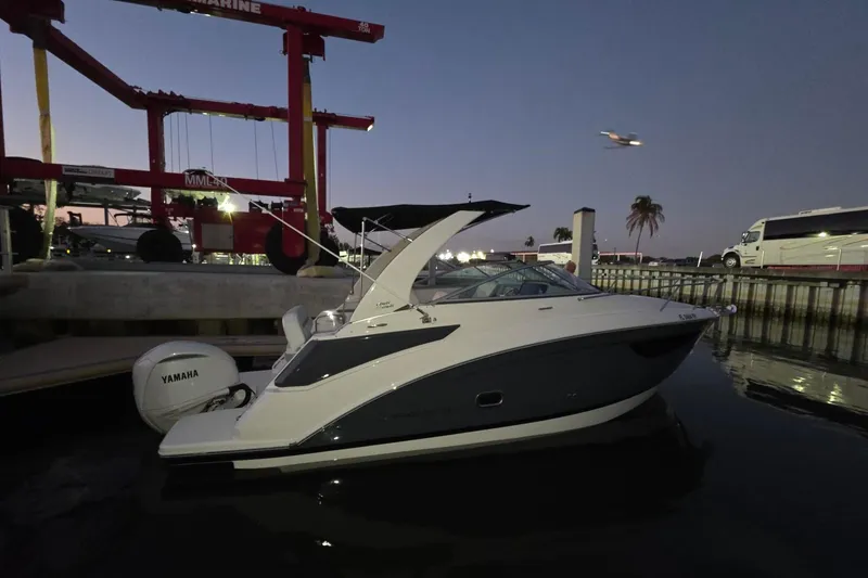 Slide: The Image of 2023 Regal 26 XO boat docked at marina during twilight, featuring Yamaha engine. - 3