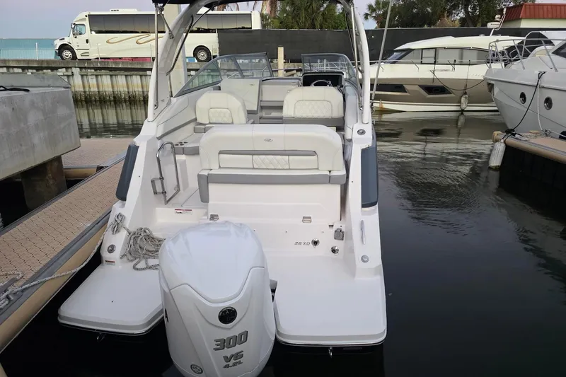 Slide: The Image of 2023 Regal 26 XO boat docked, featuring spacious seating and powerful V6 engine. - 4