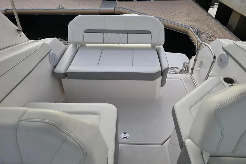 Slide: The Image of 2023 Regal 26 XO boat interior with white seating and dock view. - 5