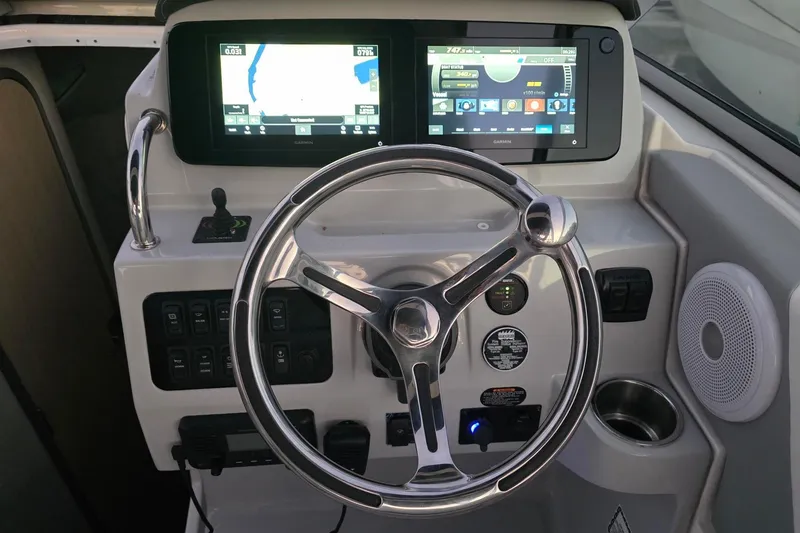 Slide: The Image of 2023 Regal 26 XO boat dashboard with steering wheel and digital displays. - 6