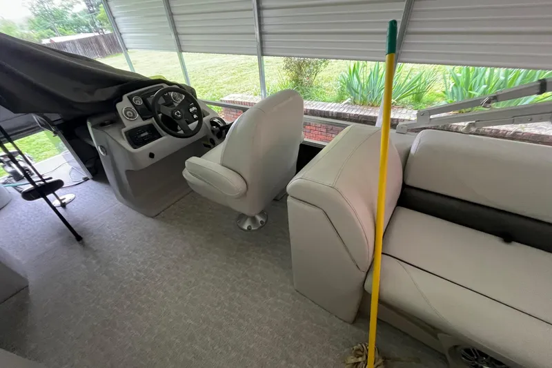 Slide: The Image of 2020 Tahoe Pontoon Sport Cruise Rear Bench 18' interior with steering console and seating. - 10