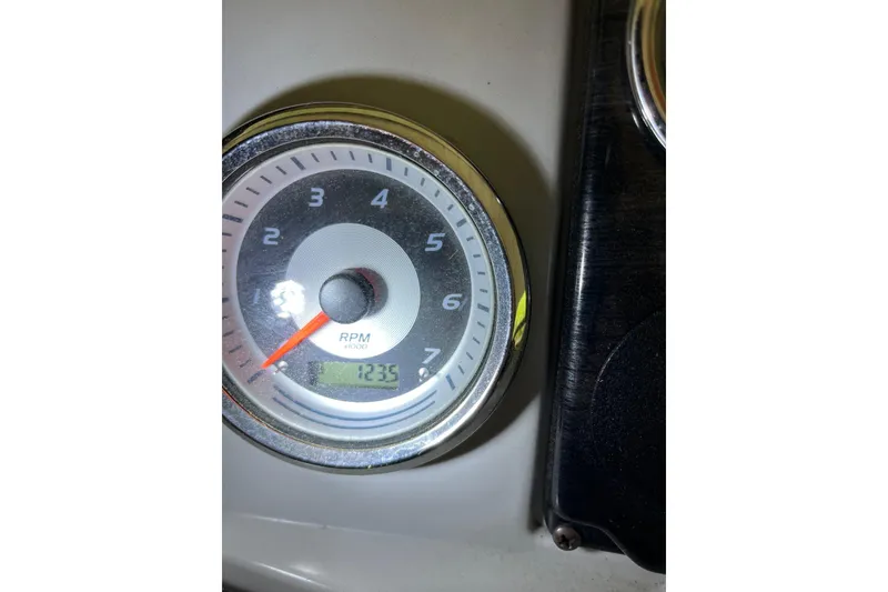 Slide: The Image of Close-up of a 2020 Tahoe Pontoon Sport Cruise RPM gauge displaying 1235 RPM. - 13