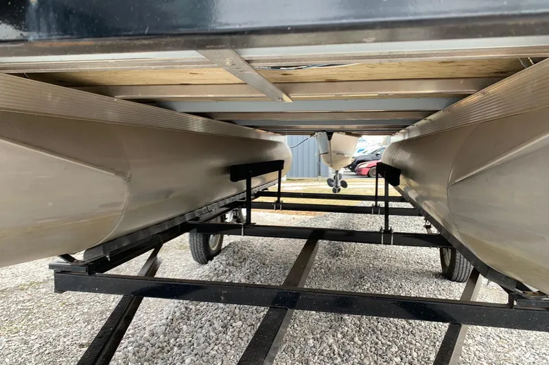 Slide: The Image of Underneath view of a 2020 Tahoe Pontoon Sport Cruise Rear Bench 18' on a trailer. - 19