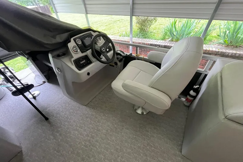 Slide: The Image of 2020 Tahoe Pontoon Sport Cruise Rear Bench 18' helm with captain's chair and controls. - 6