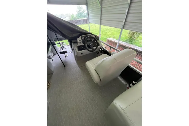 Slide: The Image of 2020 Tahoe Pontoon Sport Cruise Rear Bench 18' interior with steering wheel and seating. - 9