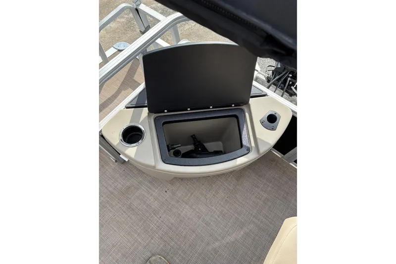 Slide: The Image of 2022 Sun Tracker Bass Buggy 18 DLX storage compartment with cup holder and open lid. - 14