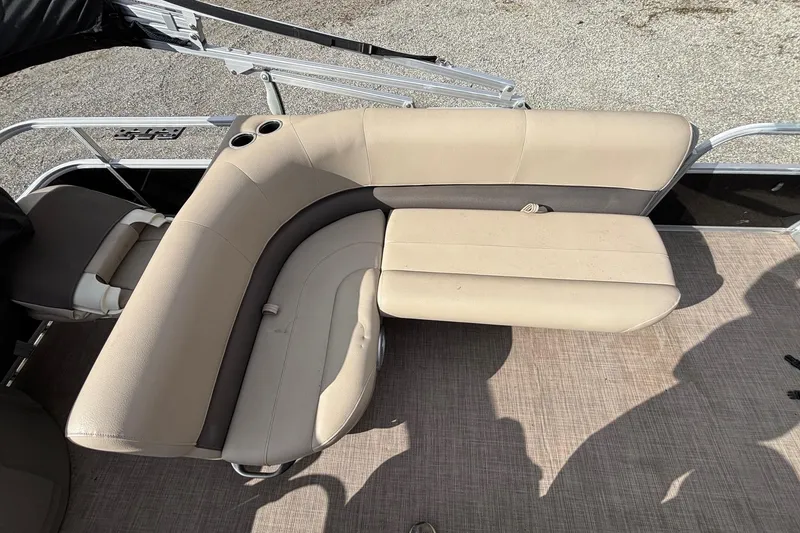Slide: The Image of 2022 Sun Tracker Bass Buggy 18 DLX pontoon boat seating area with beige upholstery. - 16