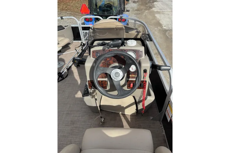 Slide: The Image of 2022 Sun Tracker Bass Buggy 18 DLX boat steering console with gauges and controls. - 20