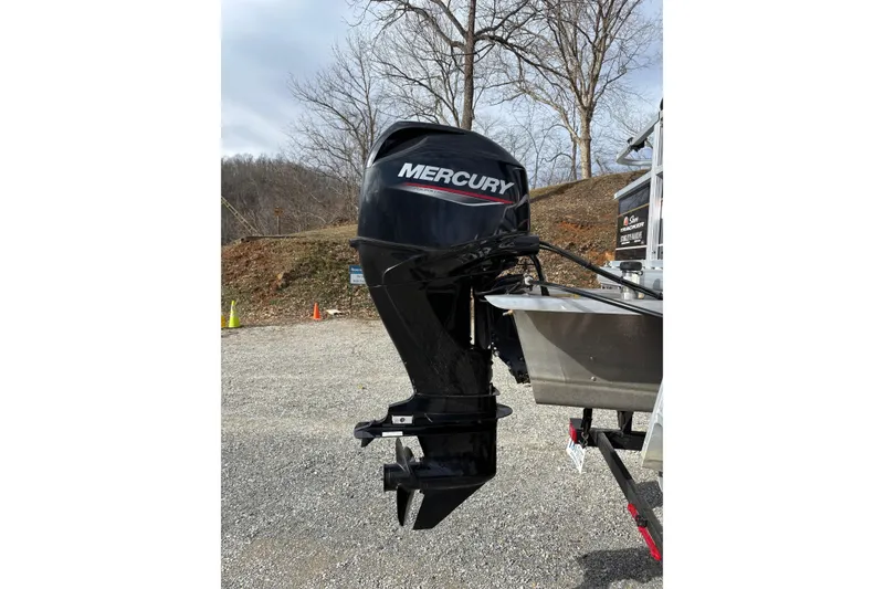 Slide: The Image of 2022 Sun Tracker Bass Buggy 18 DLX with Mercury outboard motor in a scenic outdoor setting. - 5