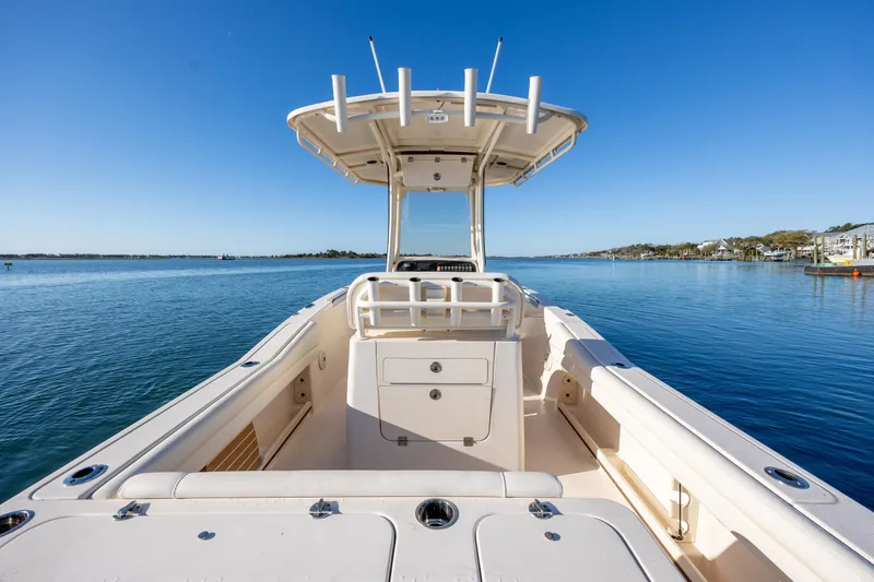 Slide: The Image of 2018 Grady-White Fisherman 236 boat on calm water under clear blue sky. - 13
