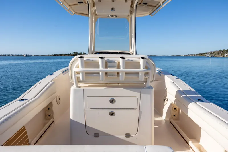 Slide: The Image of 2018 Grady-White Fisherman 236 boat on calm water, showcasing center console design. - 14