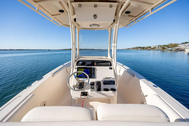 Slide: The Image of 2018 Grady-White Fisherman 236 boat on calm water, featuring a modern helm. - 19