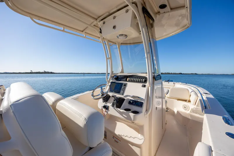 Slide: The Image of 2018 Grady-White Fisherman 236 boat interior with helm, on calm water. - 21