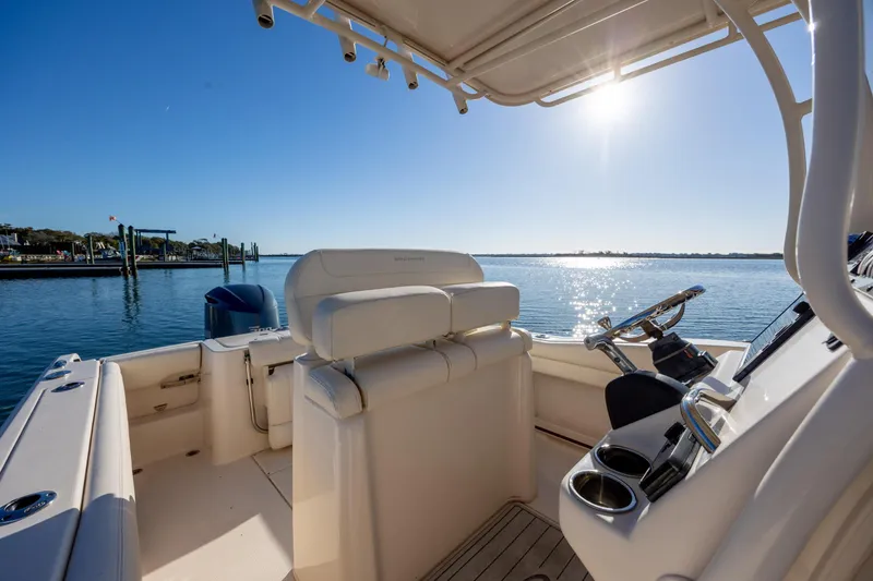 Slide: The Image of 2018 Grady-White Fisherman 236 boat interior with helm, sunny waterfront view. - 23