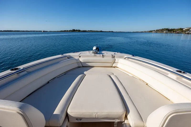 Slide: The Image of 2018 Grady-White Fisherman 236 boat on calm water, featuring spacious seating area. - 25