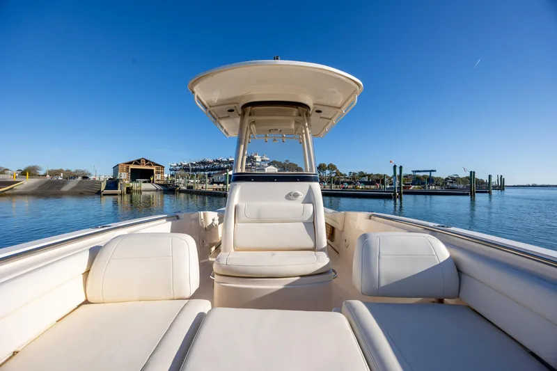 Slide: The Image of 2018 Grady-White Fisherman 236 boat docked at a marina under clear blue skies. - 27