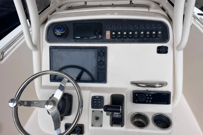 Slide: The Image of 2018 Grady-White Fisherman 236 boat dashboard with steering wheel and control panel. - 3