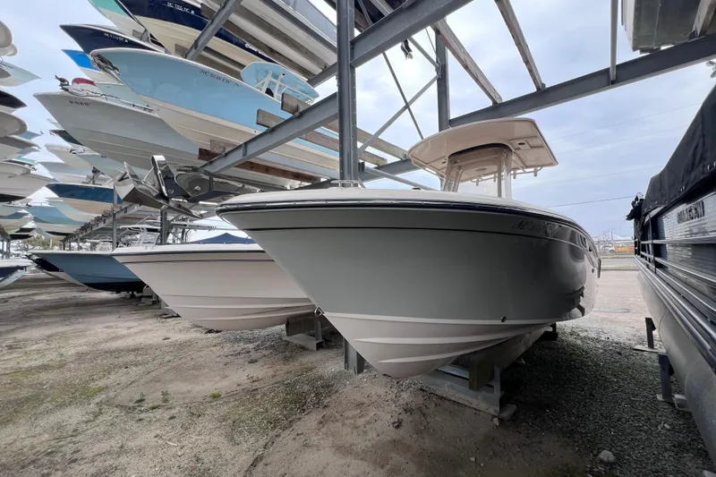 Slide: The Image of 2018 Grady-White Fisherman 236 boat in storage, surrounded by other vessels. - 7