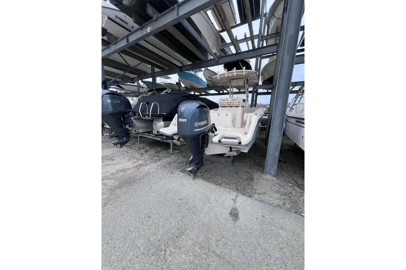 Slide: The Image of 2018 Grady-White Fisherman 236 boat stored in a marina rack, featuring Yamaha outboard engine. - 9