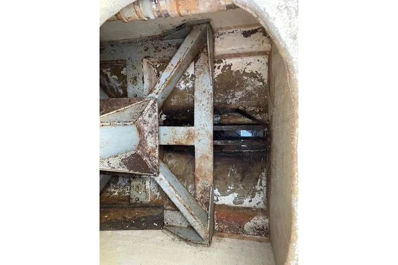 Slide: The Image of Rusty interior of a 1987 commercial buoy tender, showing metal framework and wear. - 11