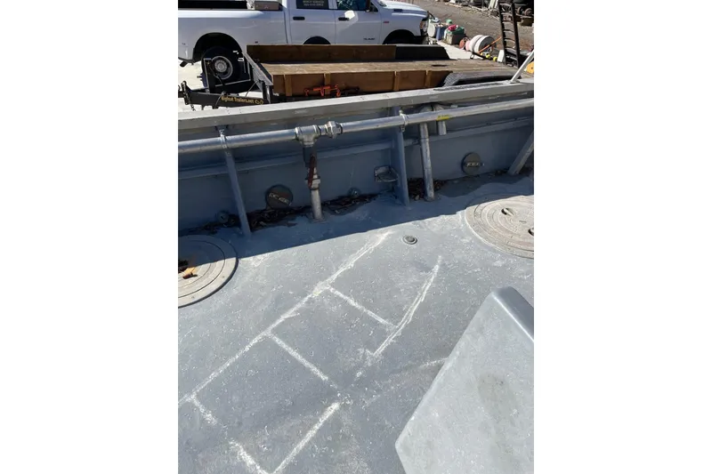 Slide: The Image of 1987 Commercial Buoy Tender deck with equipment and storage compartments. - 18