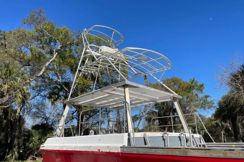 Slide: The Image of 1987 Commercial Buoy Tender with metal framework against a clear blue sky. - 22