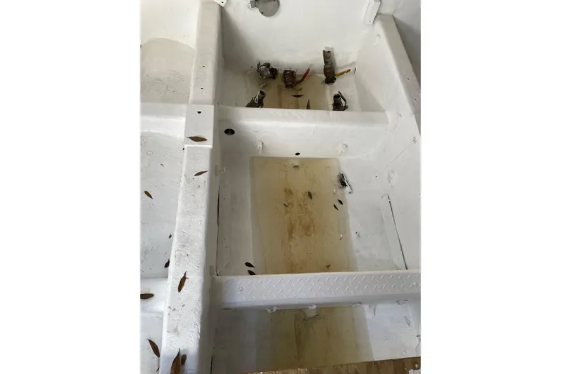 Slide: The Image of Interior of a 1987 commercial buoy tender with visible pipes and debris. - 27