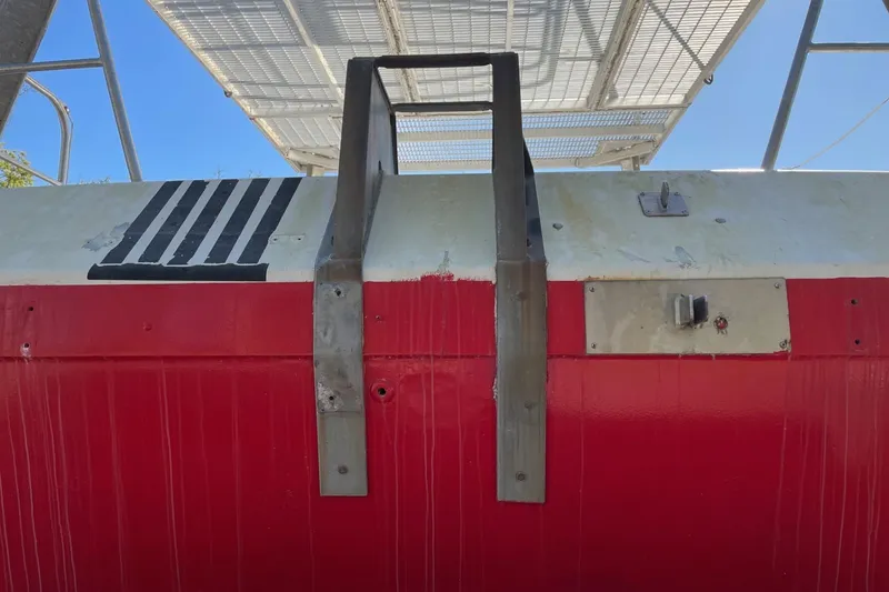 Slide: The Image of Red and white buoy tender hull with metal ladder, 1987 commercial model. - 3