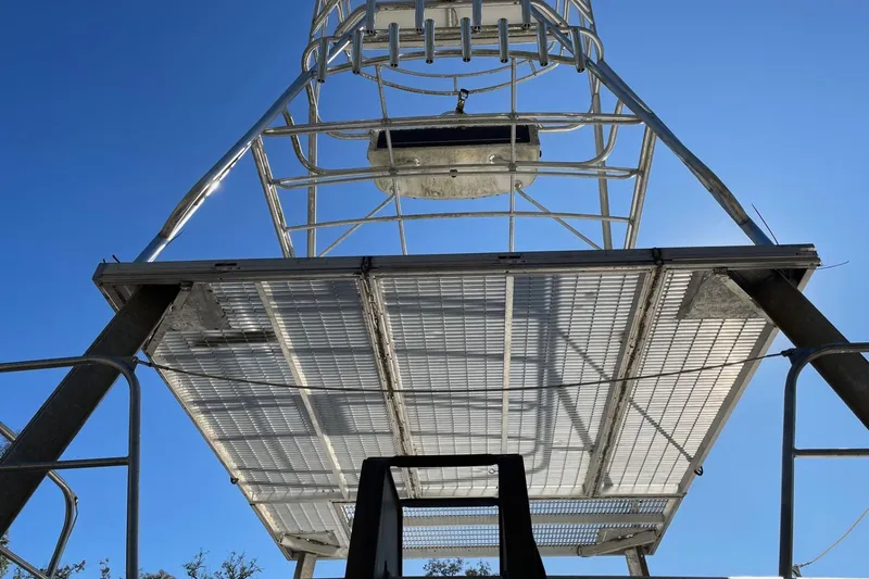 Slide: The Image of Metal structure of a 1987 Commercial Buoy Tender against a clear blue sky. - 8