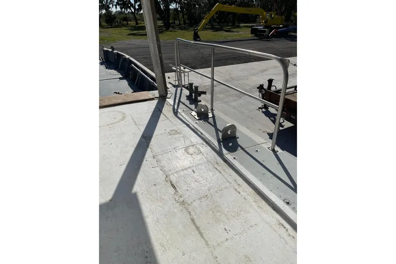 Slide: The Image of 1987 Commercial Buoy Tender deck with metal railing and outdoor equipment. - 9